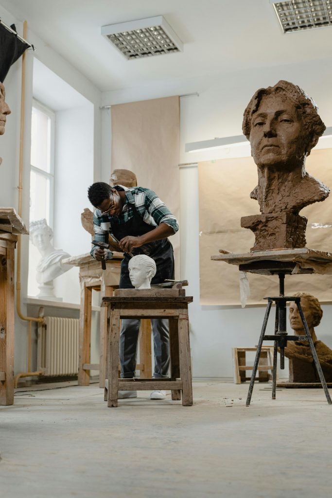 Artisan works on a ceramic bust